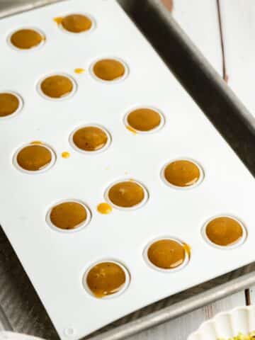 pistachio truffles in a silicone mold before setting.