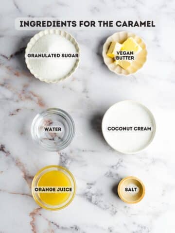 ingredients for orange caramel sauce measured out in bowls on a marble surface.