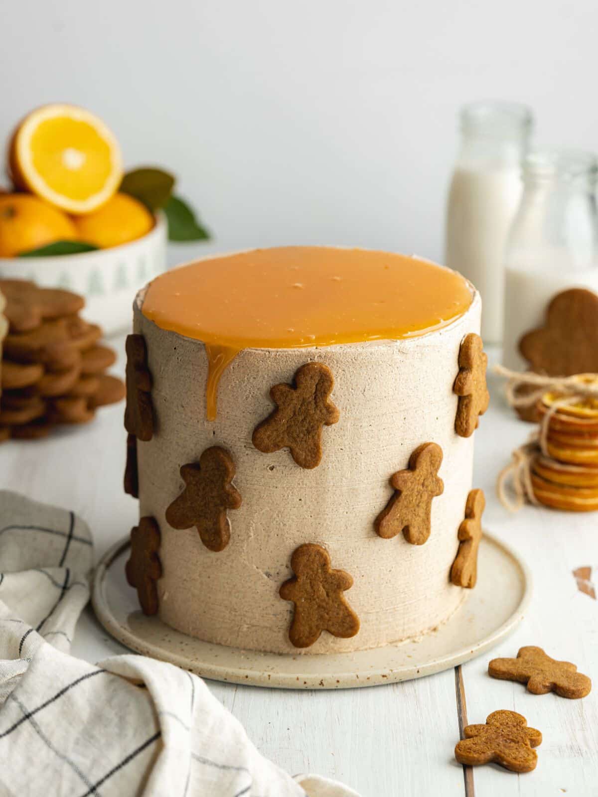 a gingerbread cake with orange caramel on top and simple gingerbread cookies stuck around the edges.