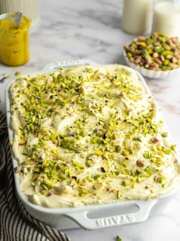 pistachio tres leches topped with pistachio whipped cream and crushed pistachios.