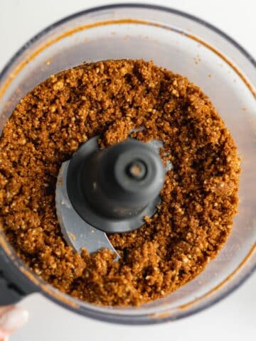 cheesecake crust resembling wet sand in a food processor jug.