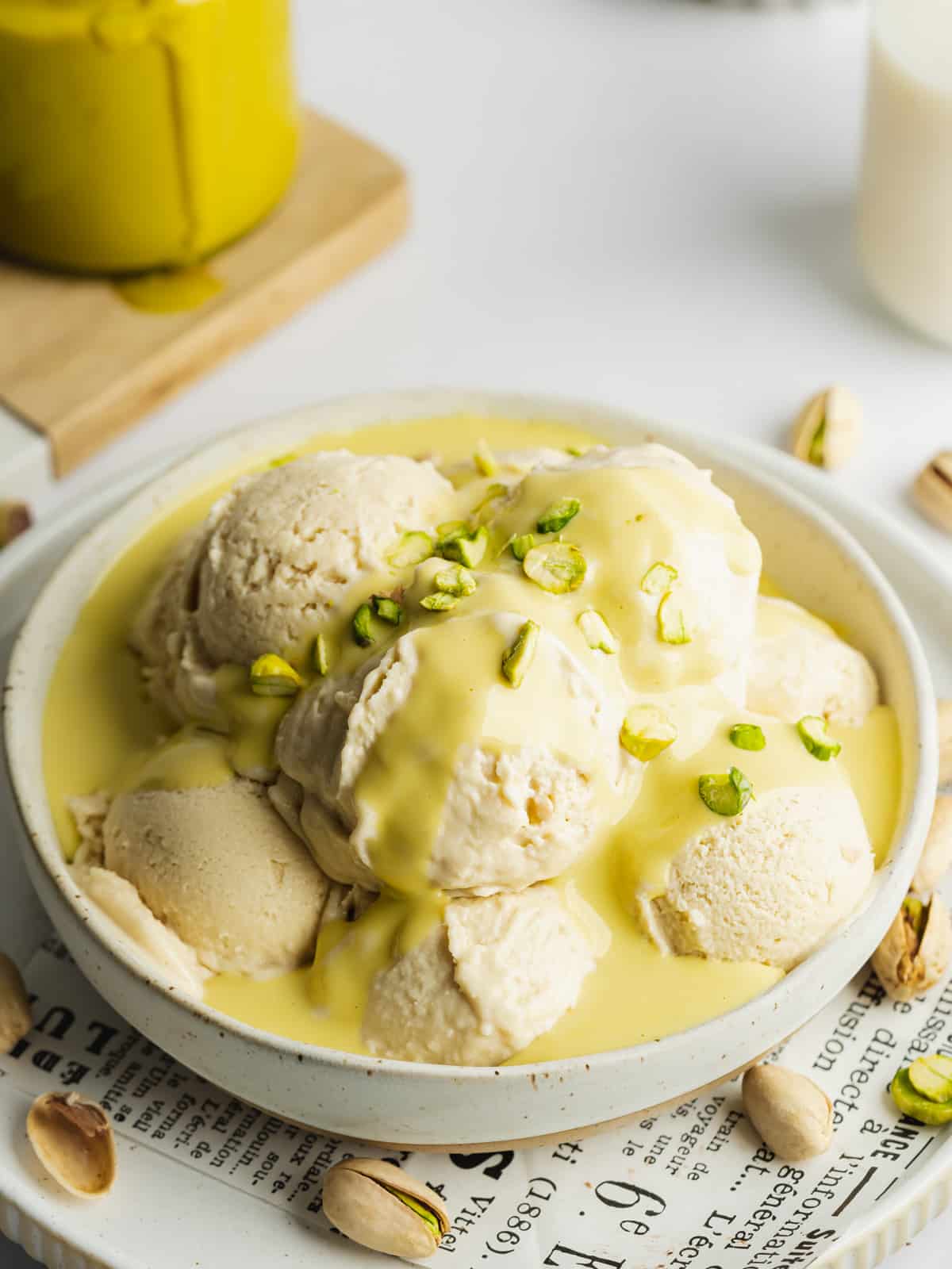 a bowl with scoops of vanilla ice cream covered in pistachio liqueur.