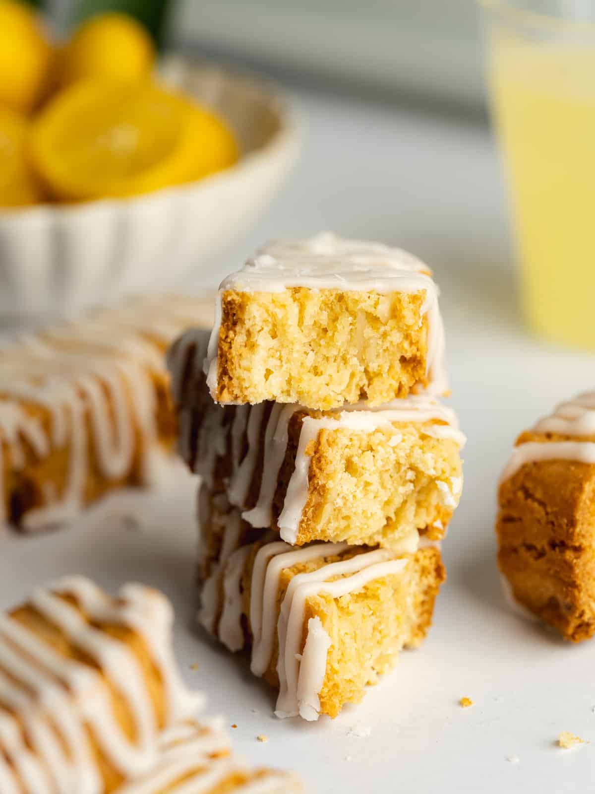 a stack of 3 lemon biscotti with lemon glaze on top.