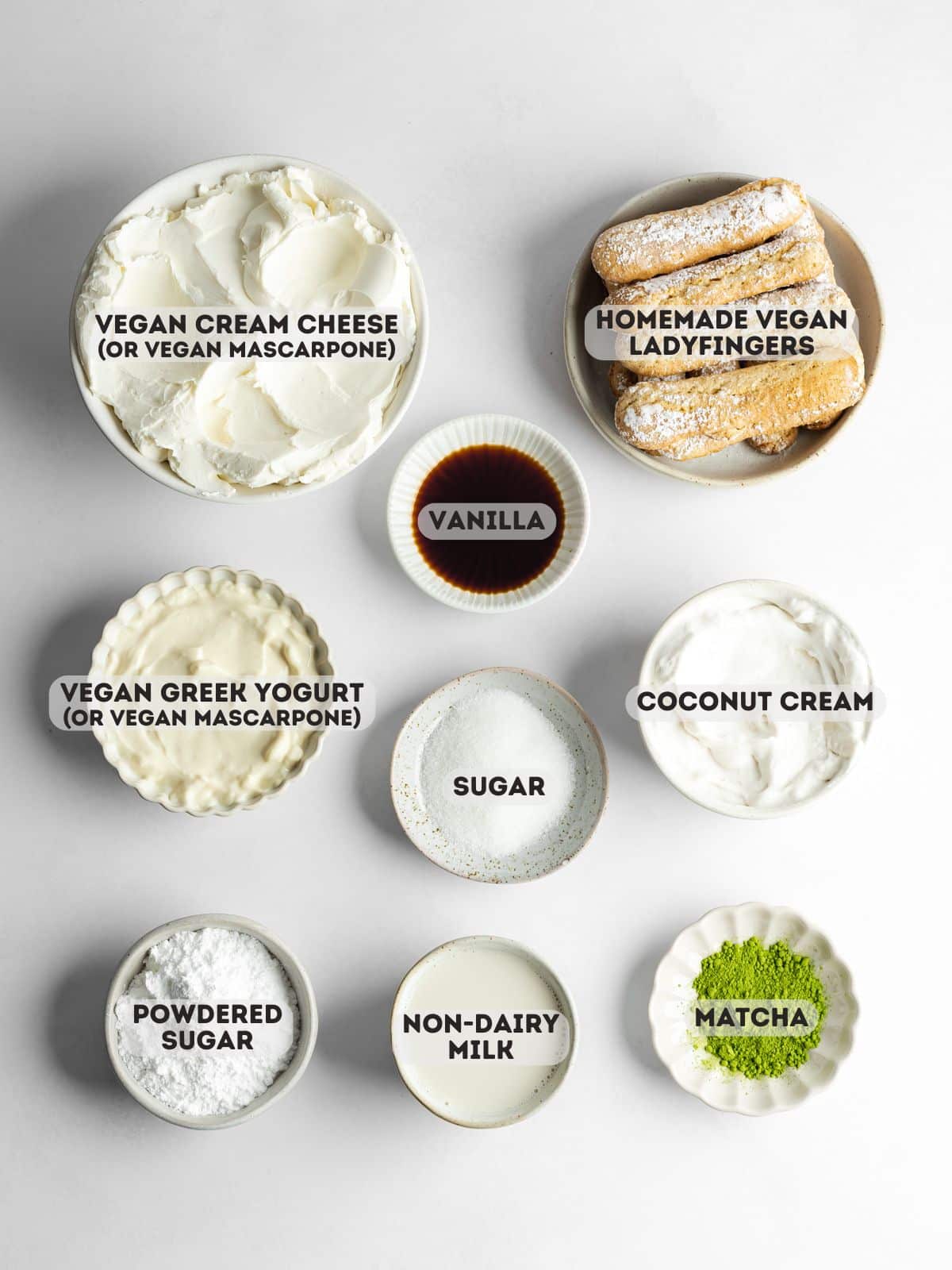 ingredients for matcha tiramisu measured out in bowls on a gray surface.