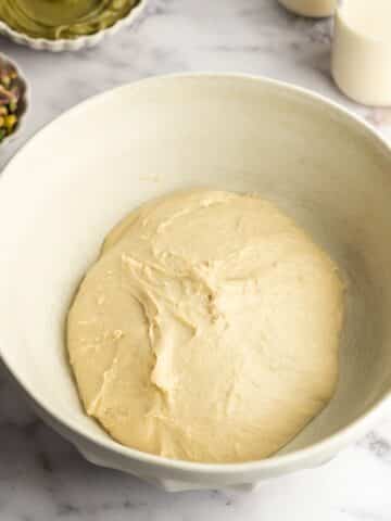 a smooth ball of cinnamon roll dough in a bowl.