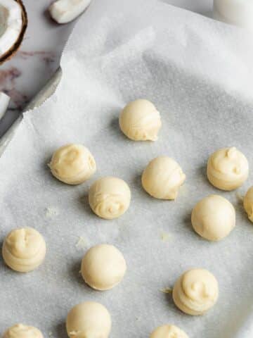 coconut truffles on a baking sheet lined with parchment.