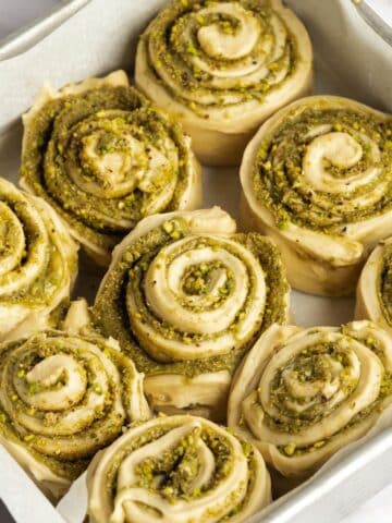 pistachio rolls in a square pan before second proof.