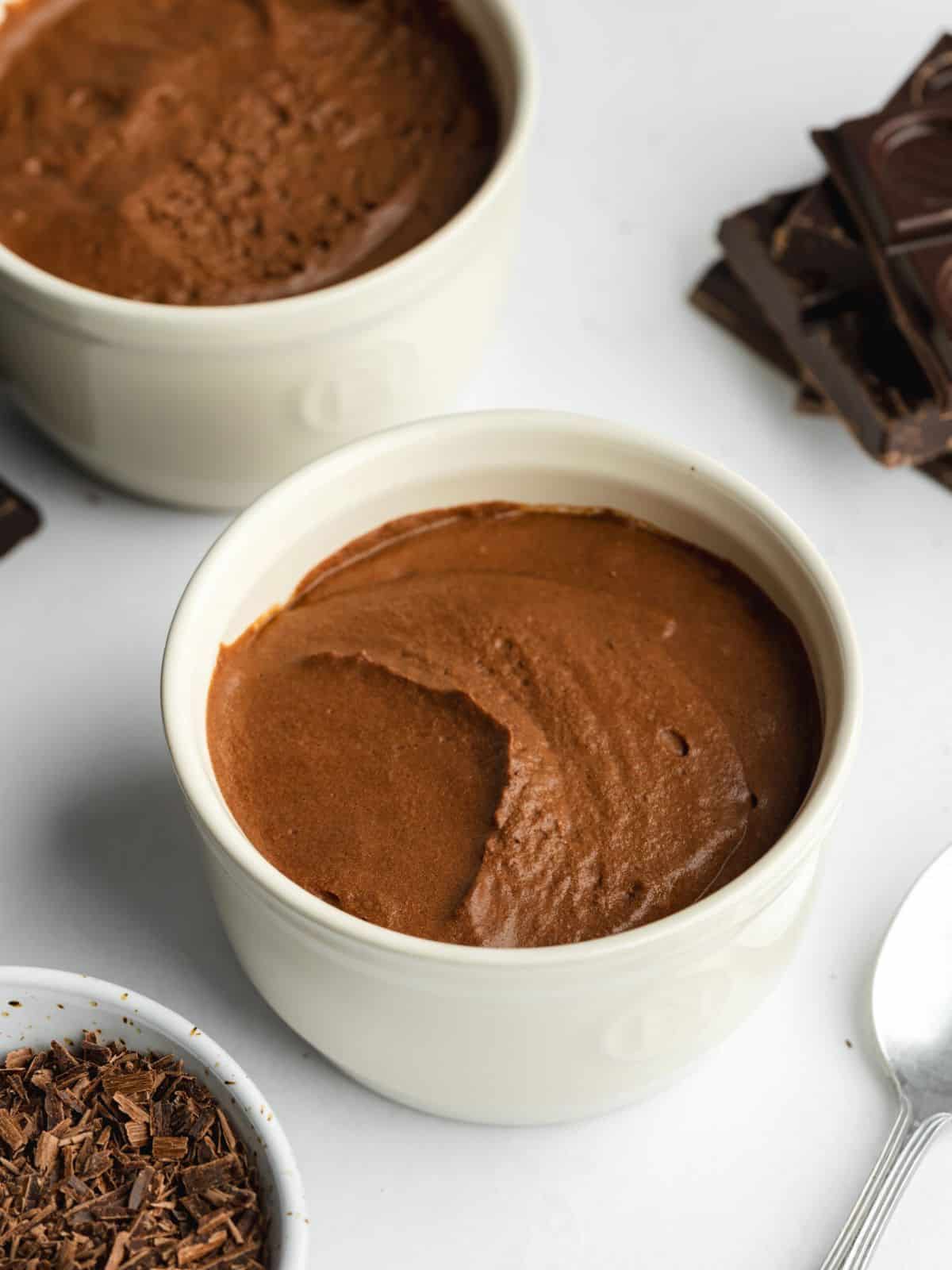 chocolate mousse divided into serving ceramic ramekins.