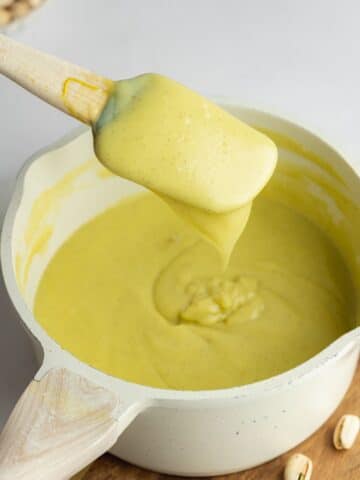 thickened pistachio custard coating the back of a spatula.
