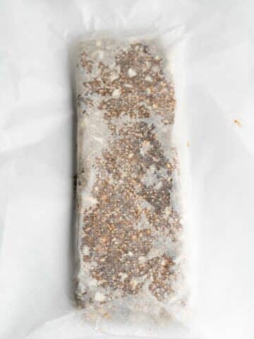 date bar shaped into a large log between 2 sheets of parchment.