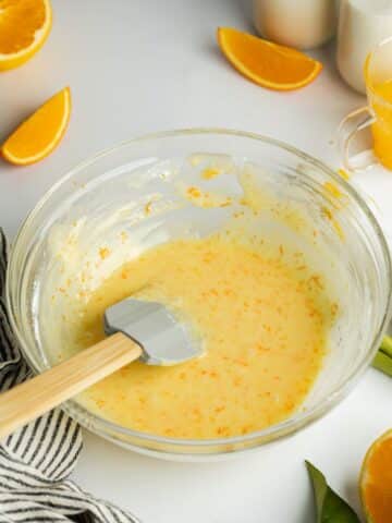 orange icing mixed together in a clear bowl.