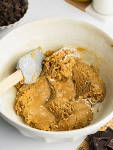 olive oil cookie dough mixed in a bowl before adding chocolate chips.