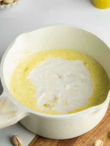 pistachio custard with coconut milk poured on top before stirring.