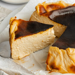 a vegan burnt basque cheesecake with a slice cut showing the creamy consistency.