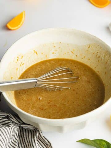 wet ingredients for orange cake whisked until smooth in a ceramic bowl.