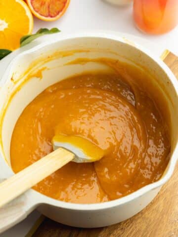 orange curd in a saucepan after thickening.