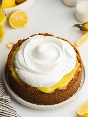 lemon cheesecake with meringue topping before it is toasted with a kitchen torch.