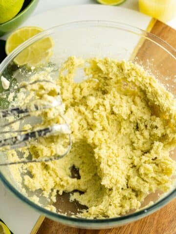 wet ingredients for lime cookie dough whisked in a mixing bowl.
