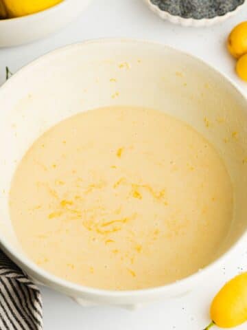 wet ingredients for lemon cake whisked in a large ceramic bowl.