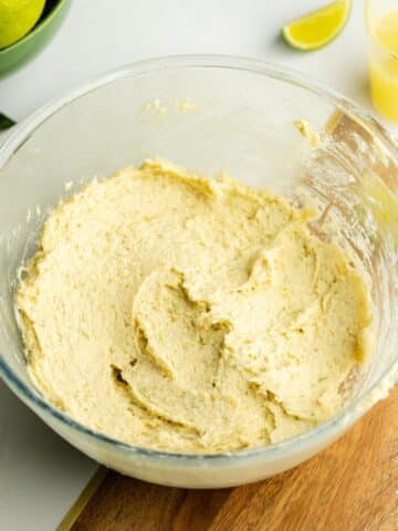 lime cookie dough in a glass bowl before going into the fridge to rest.