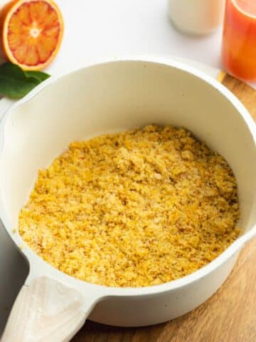 orange zest that's been rubbed into sugar in a saucepan.