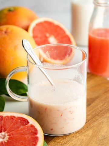 fresh grapefruit juice and soy milk mixed in a small glass jug.