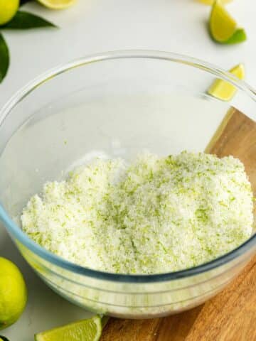 sugar in a large glass bowl with fresh lime zest rubbed into it.
