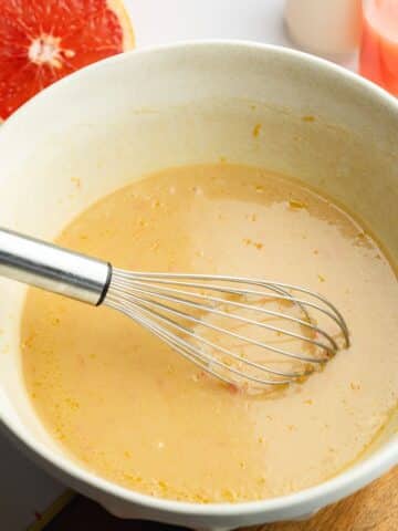 olive oil, yogurt, grapefruit juice, zest, sugar, and soy milk whisked in a large ceramic bowl.