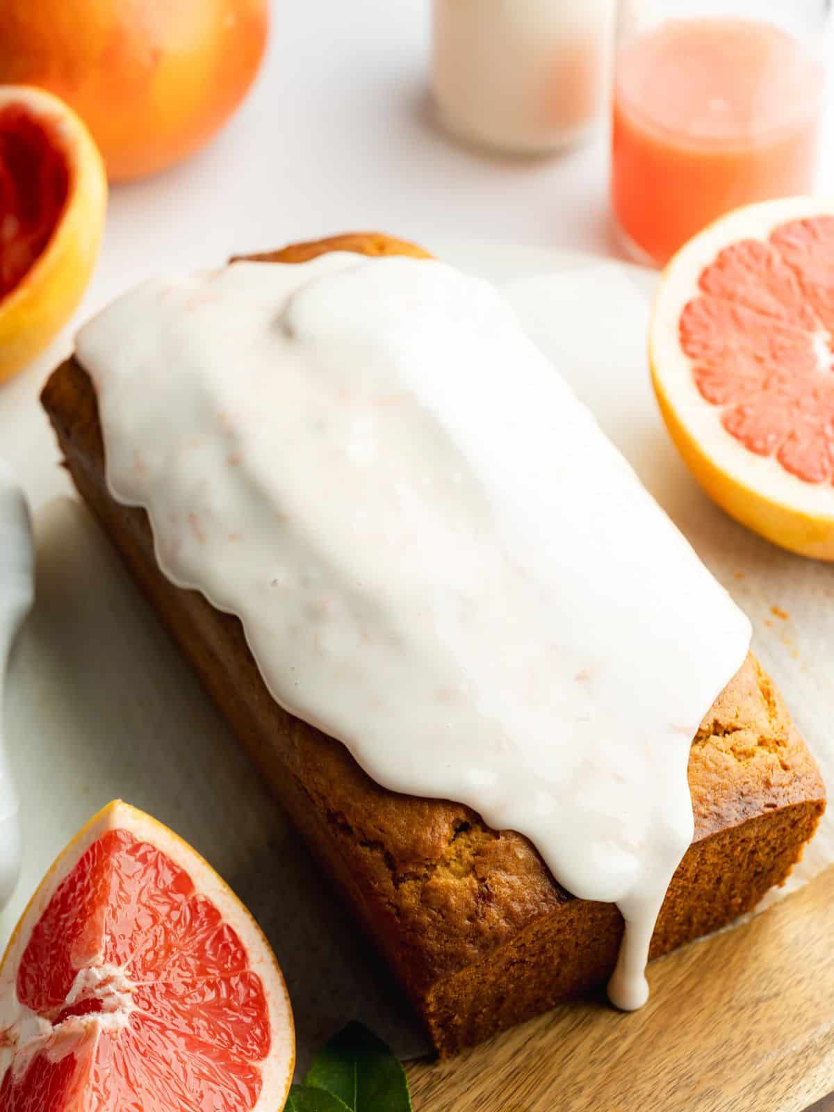 vegan loaf cake covered with thick grapefruit sugar glaze.