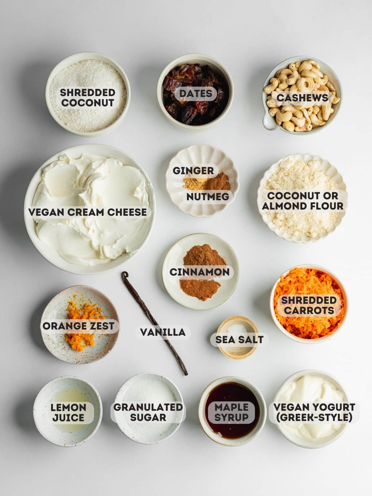 ingredients for carrot cake cheesecake measured out in bowls on a gray surface.