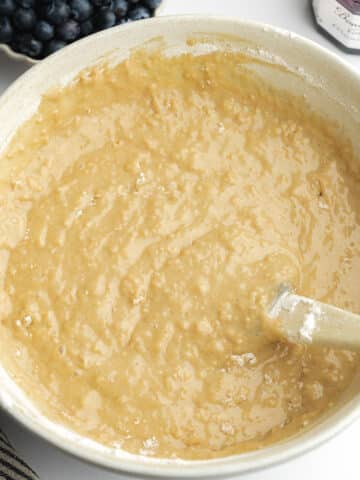 muffin batter resting in a ceramic bowl before baking.