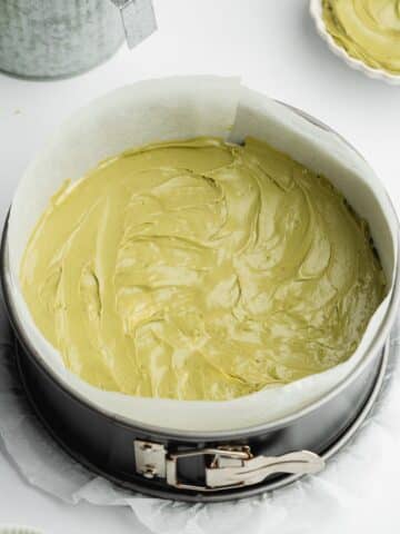 pistachio cake with an even layer of pistachio cream spread before adding more batter and baking.