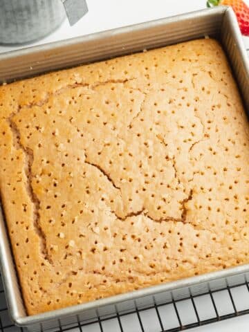 strawberry cake with holes poked in it.