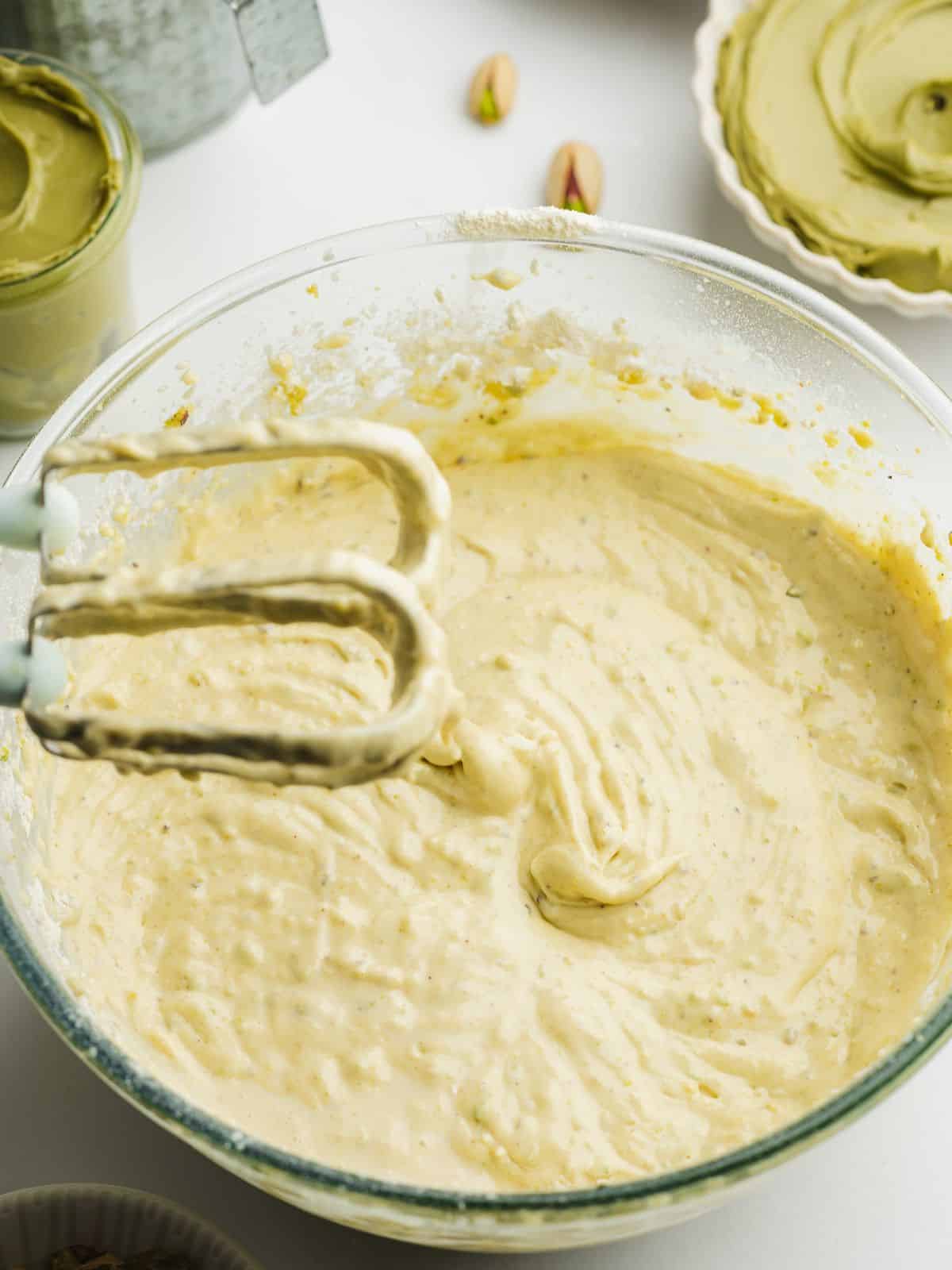 pistachio cake batter in a clear bowl.