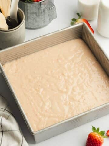 strawberry cake in a square pan before baking.