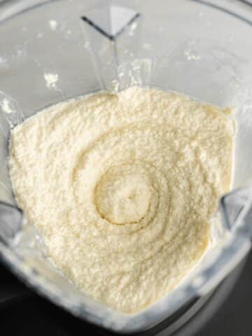 soaked macadamias, dairy-free yogurt, nooch, vinegar, and salt blended until creamy in a high-speed blender jug.