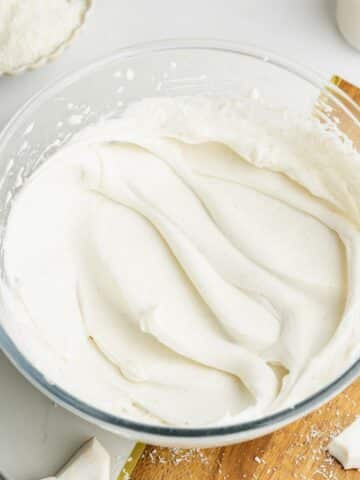 whipped coconut cream and cream cheese with specs of real vanilla in a bowl.
