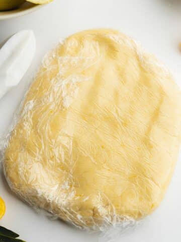 lemon cookie dough wrapped in clingfilm before chilling.
