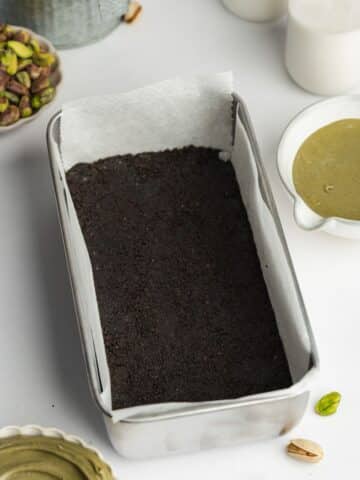 oreo crust pressed into a lined loaf pan.