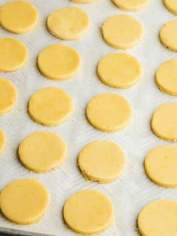 lemon cut out cookies on a baking sheet lined with parchment paper.