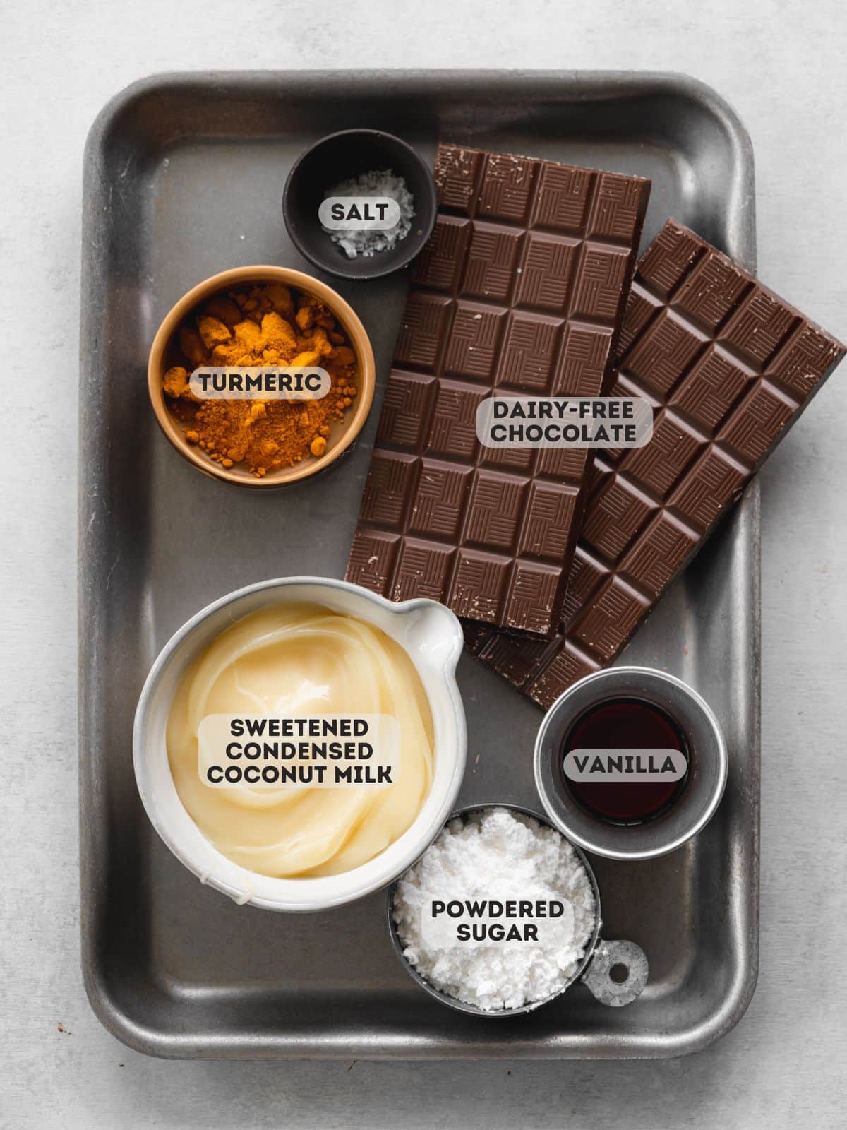 ingredients for filled easter eggs measured out in bowls on a tray.