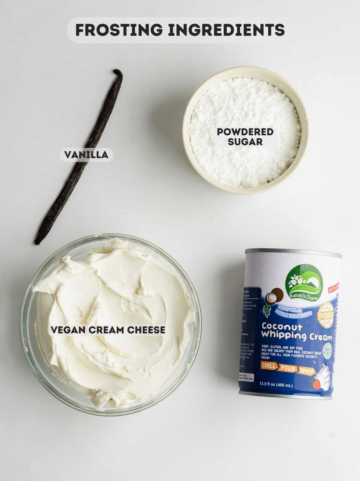 ingredients for coconut cream cheese frosting measured out in bowls on a gray surface.