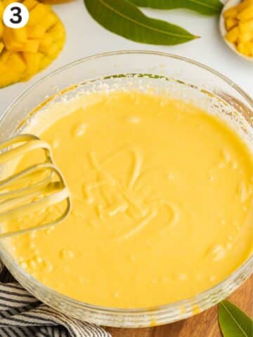 mango ice cream whipped in a mixing bowl before being transferred into a loaf pan.