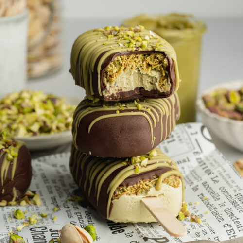 a stack of three pistachio magnum ice cream bars on top of each other.
