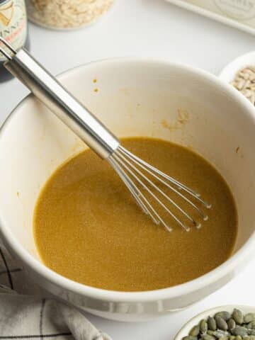 wet ingredients for brown bread whisked in a bowl.
