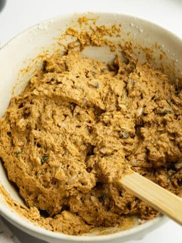 brown bread dough in a ceramic bowl.