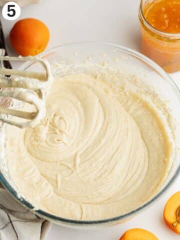 vanilla cake batter in a mixing bowl with a hand mixer.