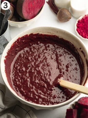 chocolate beetroot cake batter mixed in a ceramic bowl.