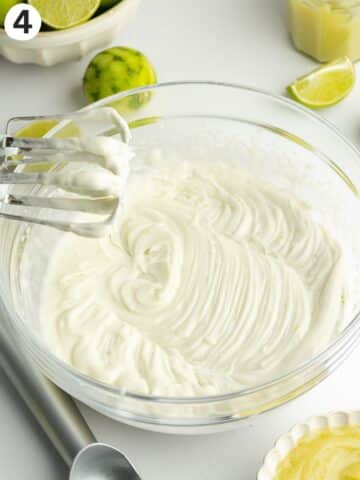 lime ice cream in a bowl whipped with a hand mixer.