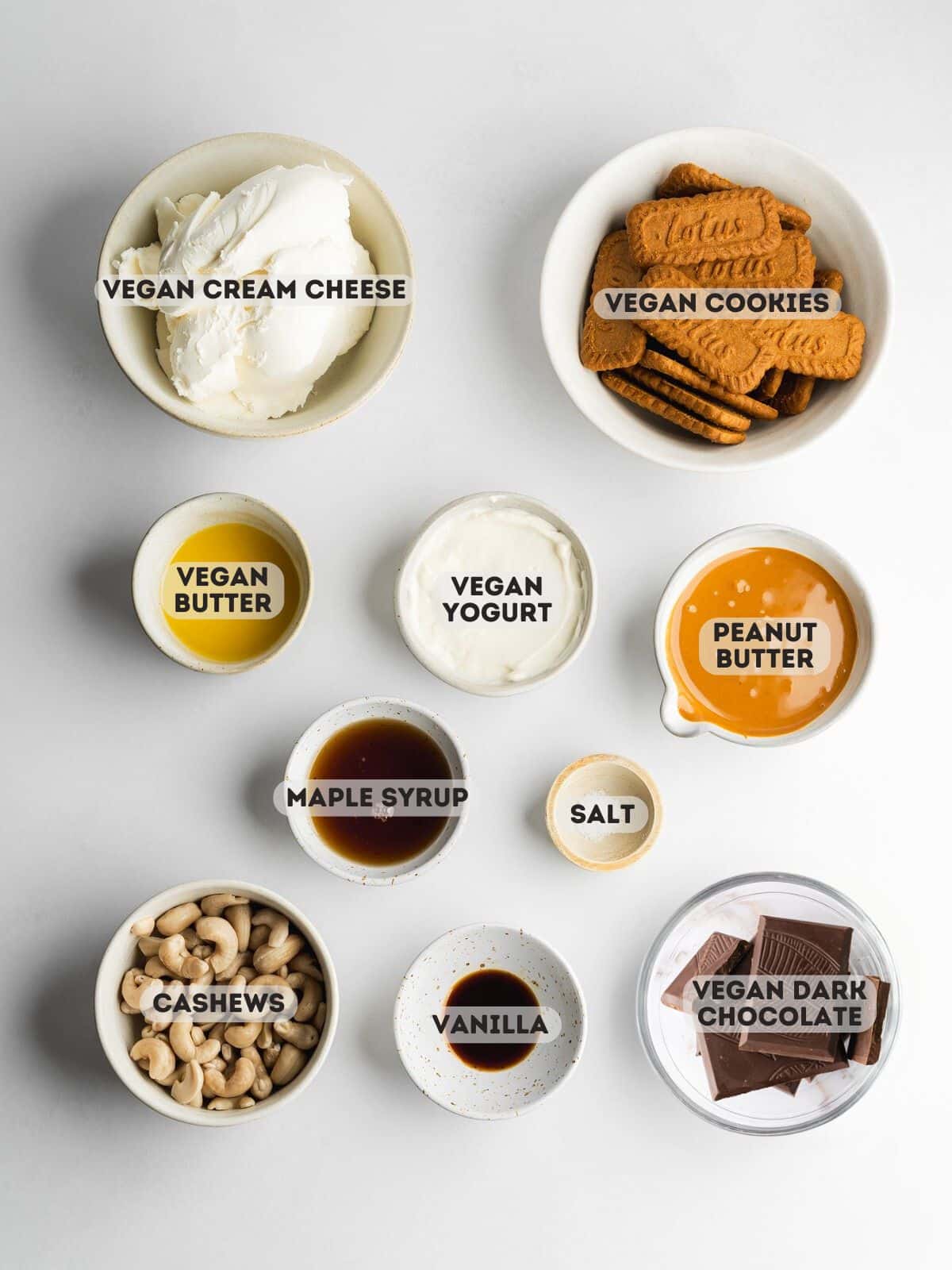 ingredients for peanut butter cheesecake measured out in bowls.